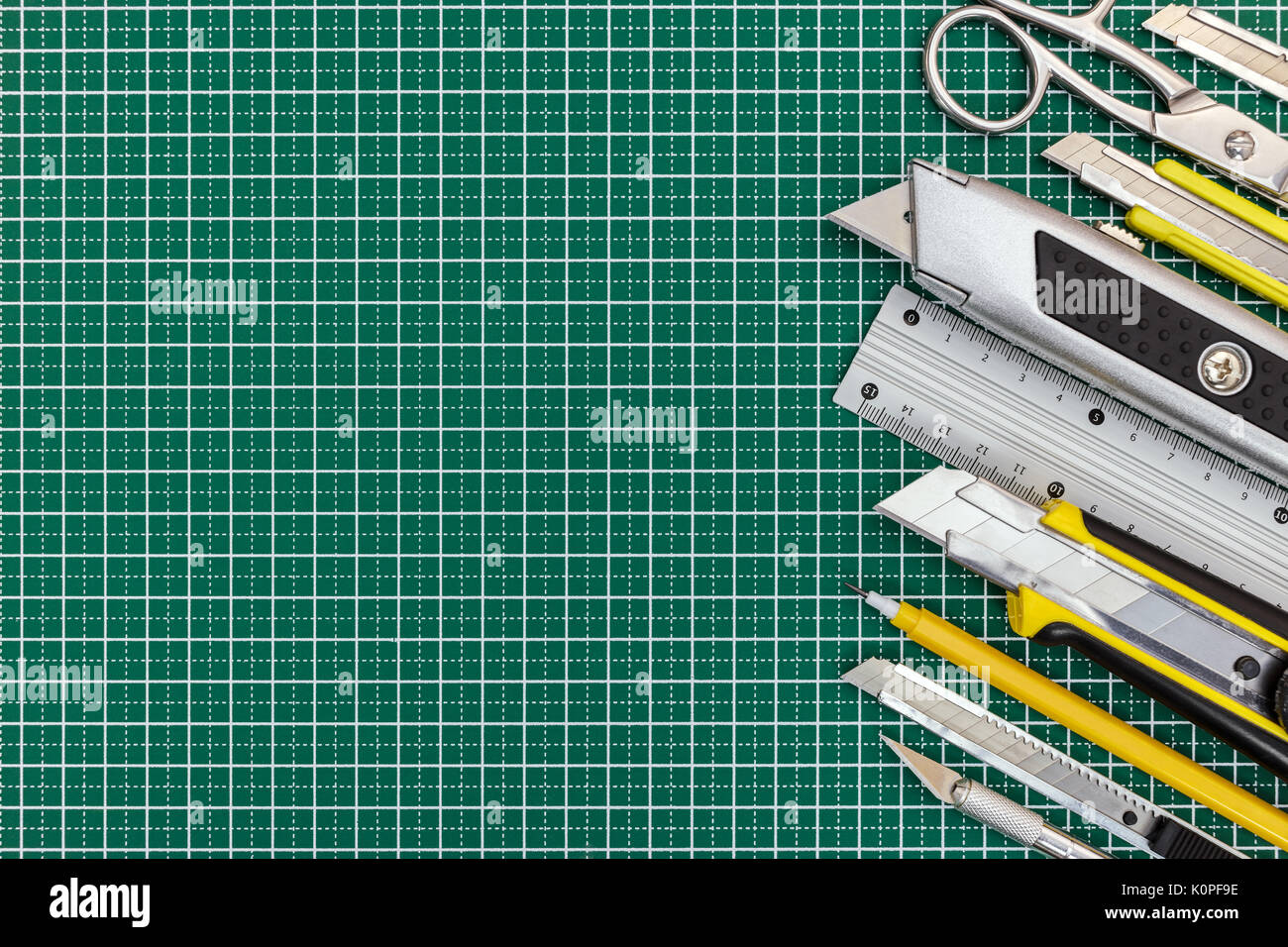 school tools and office supplies on green cutting mat background, top view  Stock Photo - Alamy
