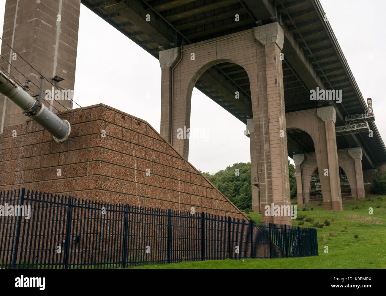 View from under Forth Road Bridge with arched concrete bridge struts and cable, North Queensferry, Fife, Scotland, UK Stock Photo