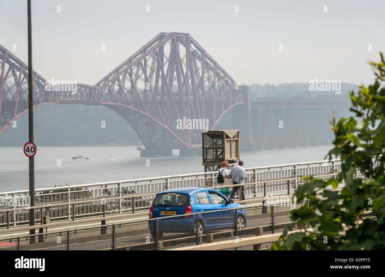 Cars traveling on Forth Road Bridge and couple walking on bridge, before diversion to new Queensferry Crossing, opening on August 30th 2017, Scotland Stock Photo