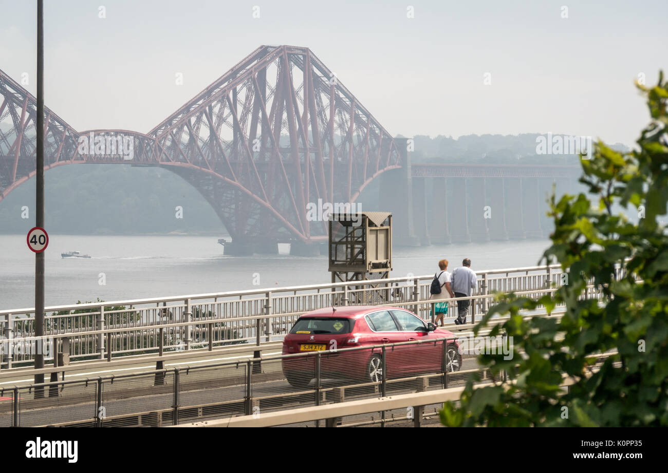 Cars traveling on Forth Road Bridge and couple walking on bridge, before diversion to new Queensferry Crossing, opening on August 30th 2017, Scotland Stock Photo