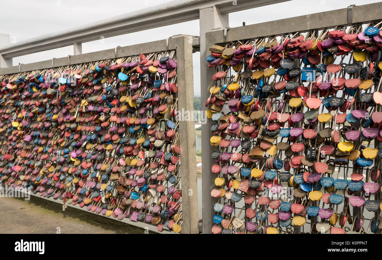 Bridge railings with mass of colourful love locks on pedestrian walkway of Forth Road Bridge, Firth of Forth, Scotland, UK Stock Photo