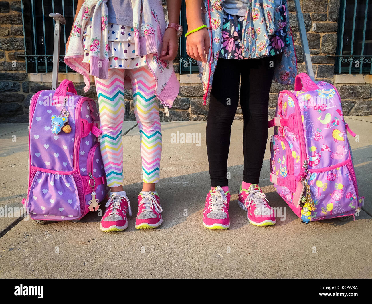 Two Elementary student with rolling backpack Stock Photo