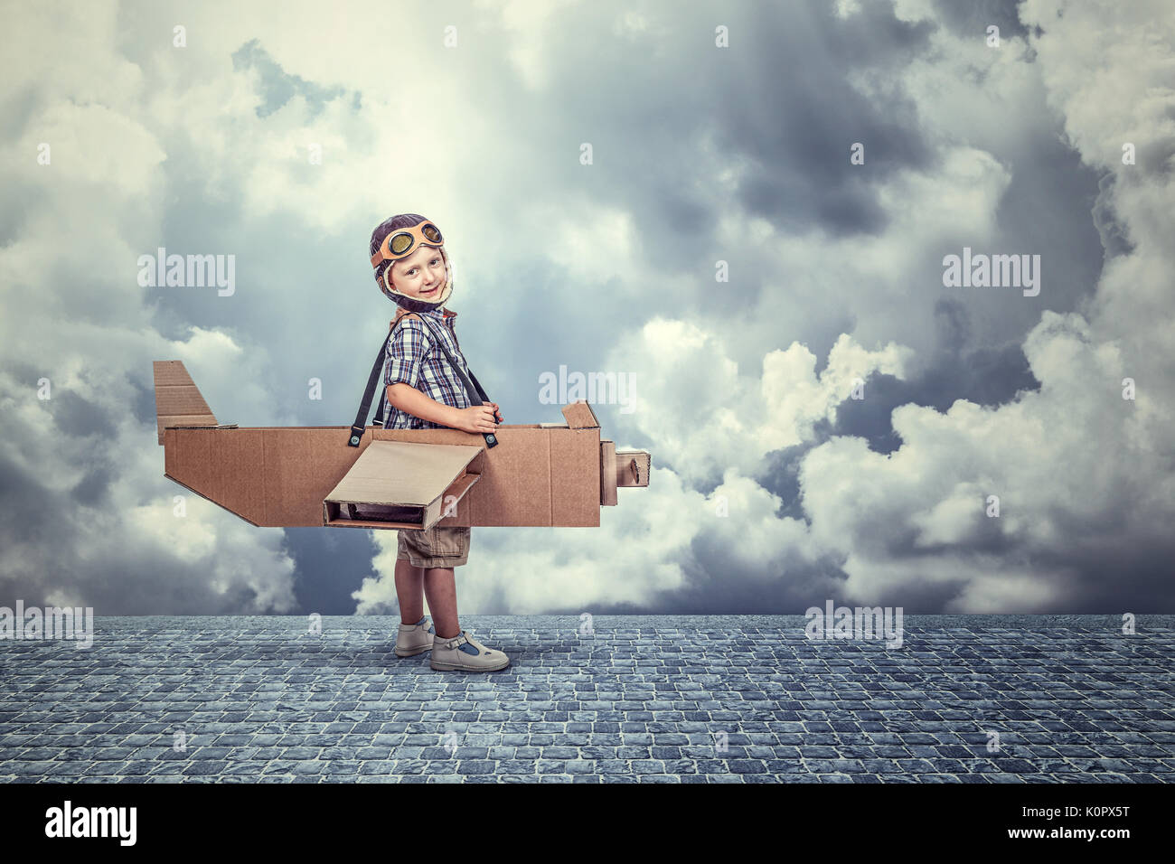 smiling kid with cardboard airplane Stock Photo