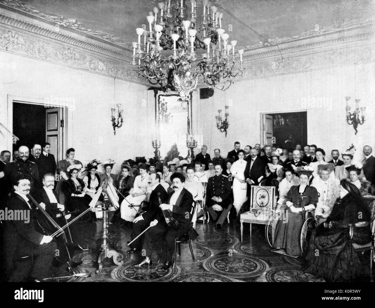 Russian music  matinée in pre-reolutionary St Petersburg /   Saint Petersburg at Duke of Mecklembourg.  Quartet includes Sigis Butkiewitch,  Alex Borneman, Naun Kranz, B. Kamensky .  With  Cesar Cui in the front row Musical gathering in Tsarist Russia c.1908 Stock Photo