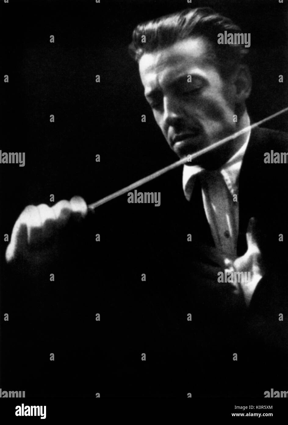 Herbert von Karajan - portrait of the Austrian conductor conducting with baton in early 1940s. 5 April 1908 - 16 July 1989. Stock Photo