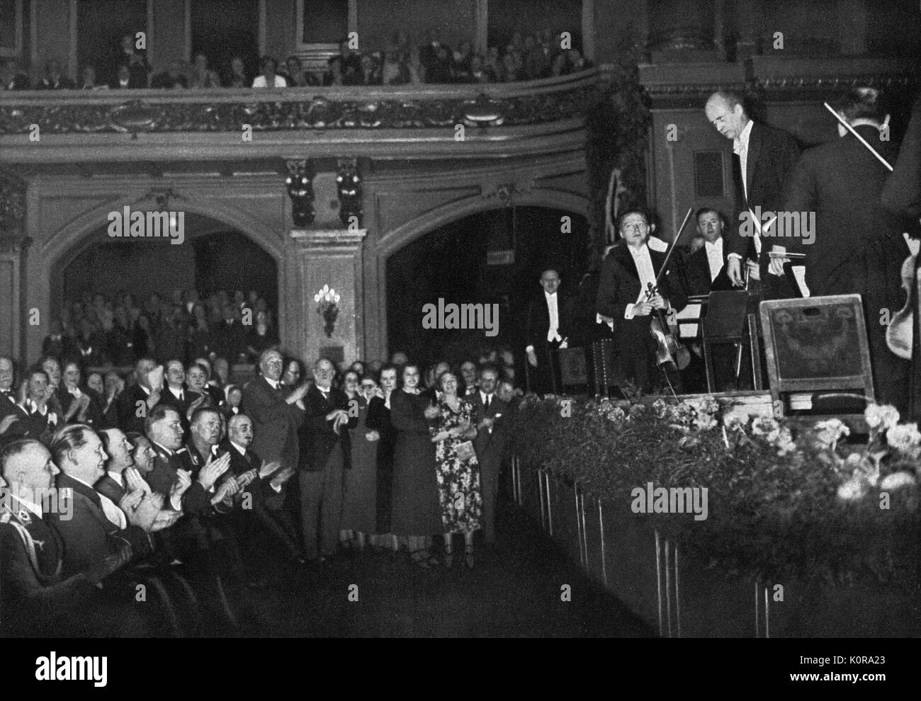 Wilhelm FURTWÄNGLER bowing  (on stage) & Hitler (in audience) clapping with his ministers during Third Reich. German conductor and composer 1886 - 1954.  Third Reich identifying with classical music culture. Stock Photo