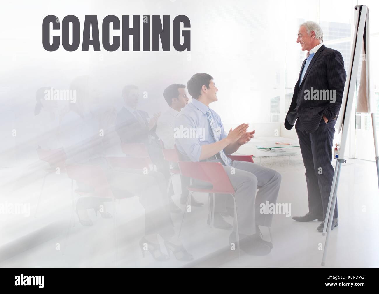 Digital composite of Coaching text and Business economics teacher with class Stock Photo