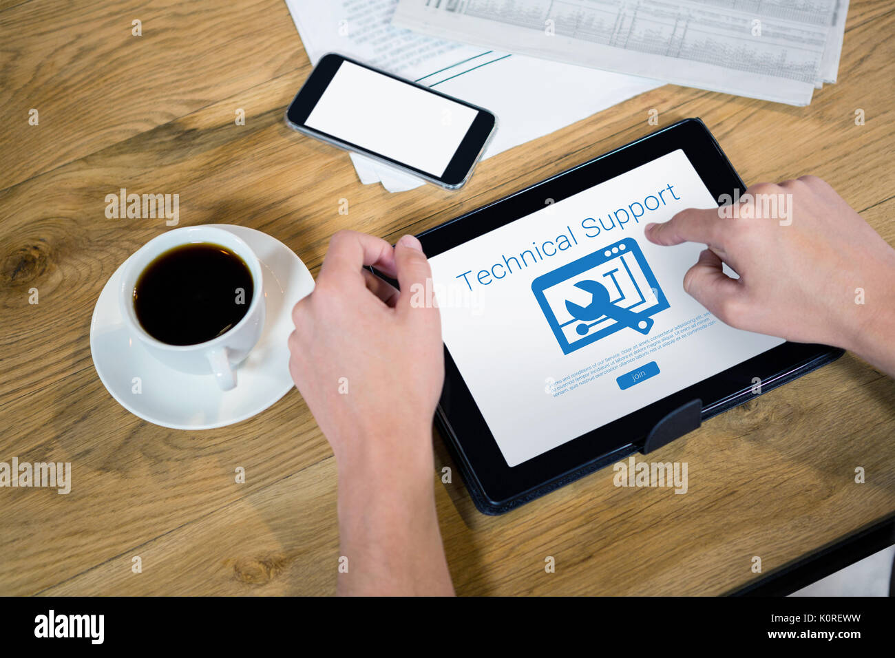 Tool with technical support text against cropped hands using tablet computer at table Stock Photo