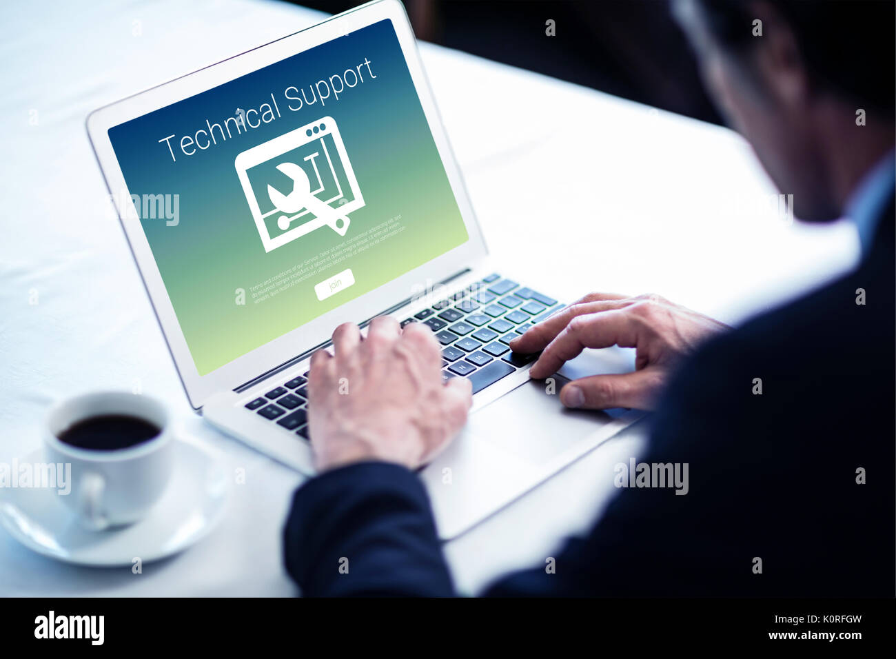 Technical support text with tool against businessman using his laptop at restaurant Stock Photo