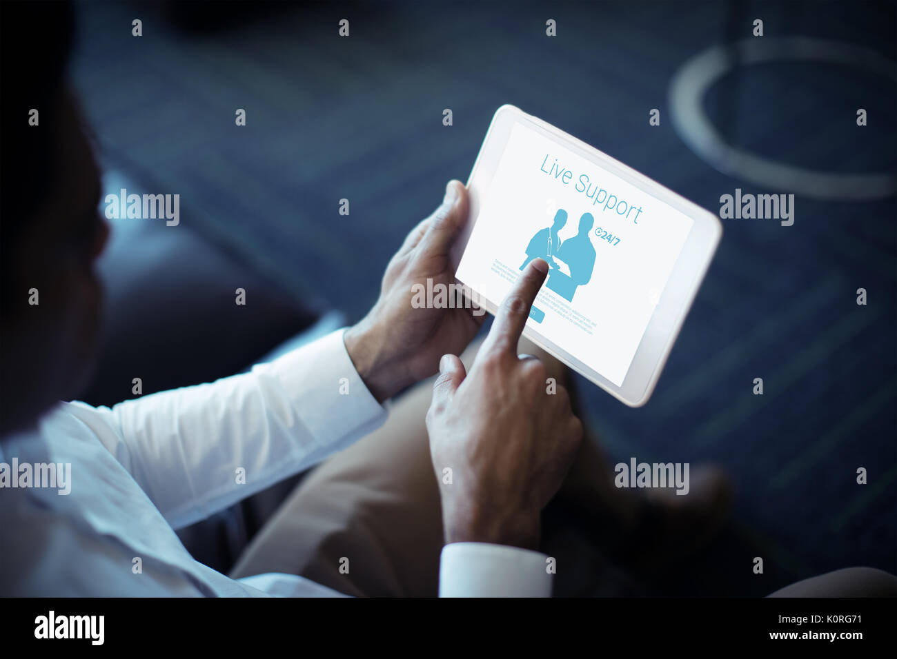Live support text with human representations against cropped image of businessman using tablet Stock Photo