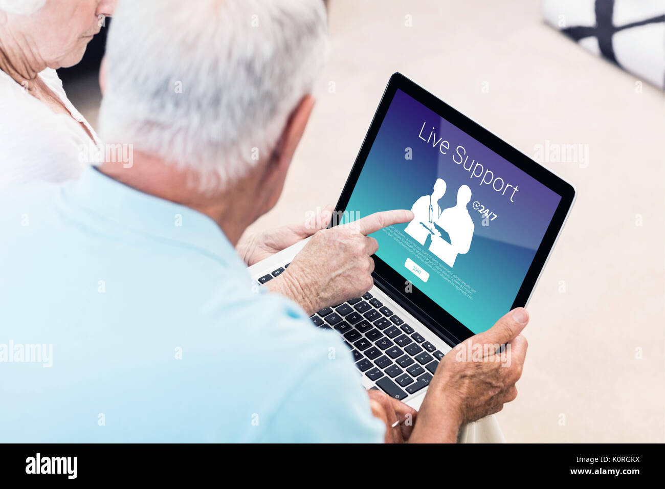 Human representations with live support text against focused senior couple using laptop Stock Photo