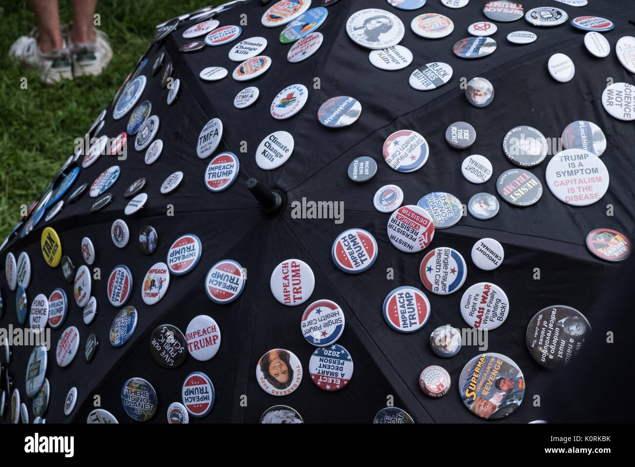 Anti Trump Buttons and Badges pinned to an umbrella at a recent anti-hate rally in Middletown NY Stock Photo