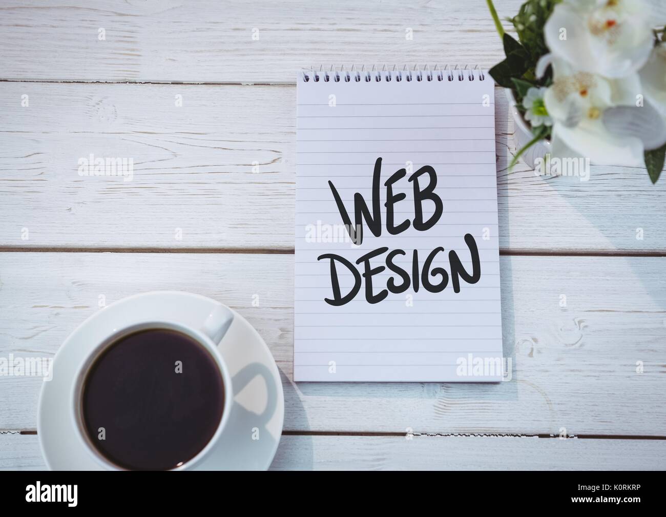 Digital composite of Table top with a notebook with web graphics Stock Photo