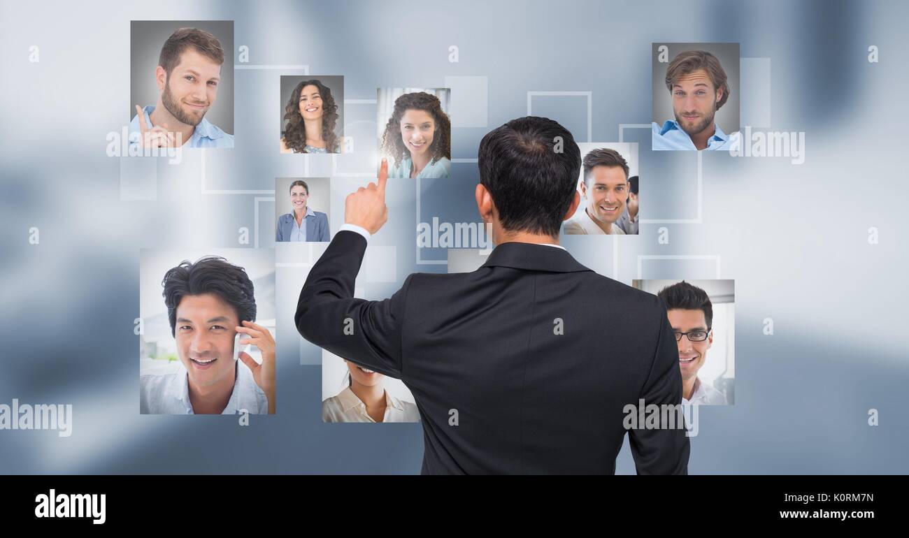 Digital composite of Businessman interacting and choosing a person from group of people interface Stock Photo