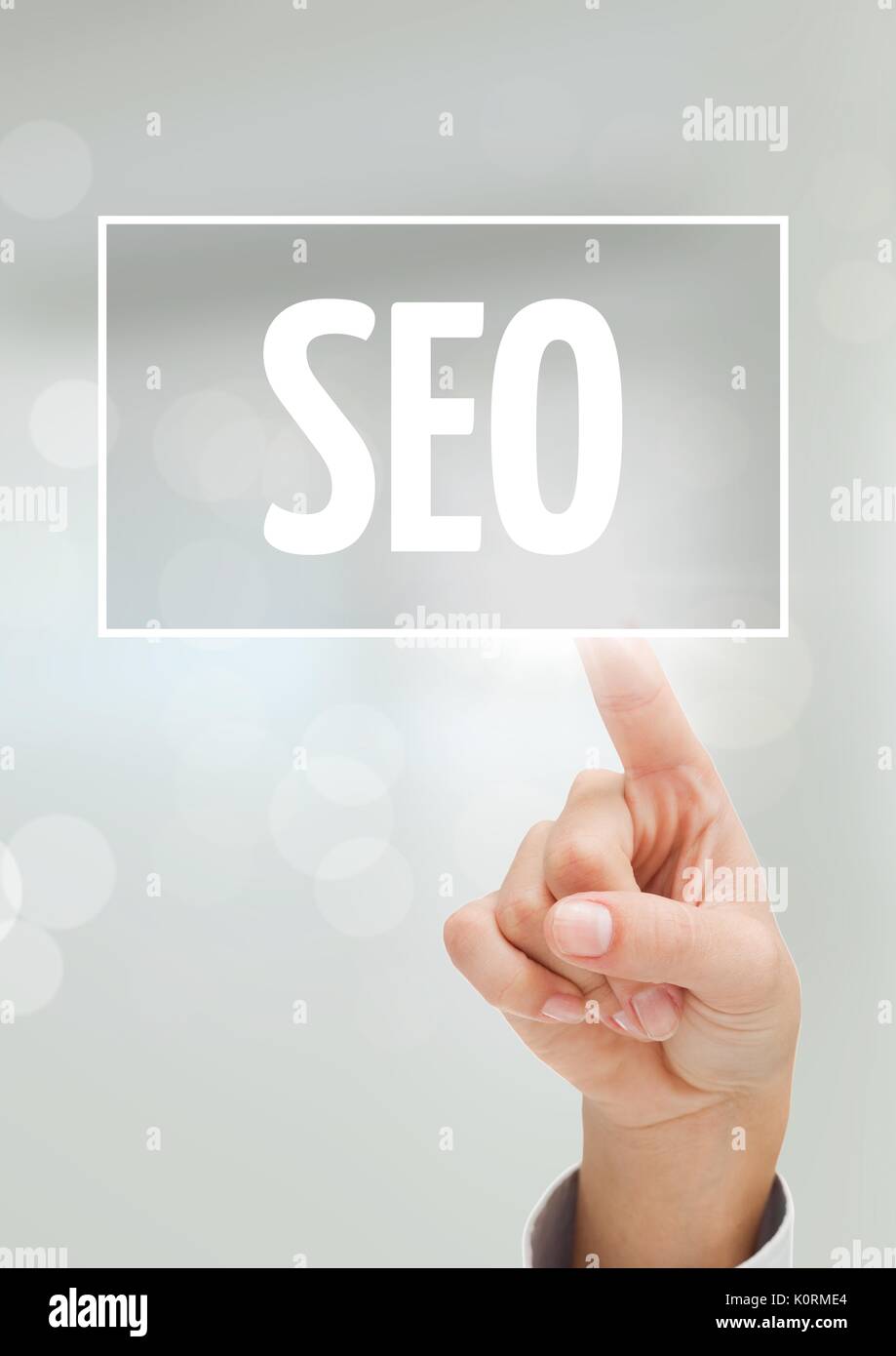 Digital composite of Hand interacting with SEO business text against white background Stock Photo