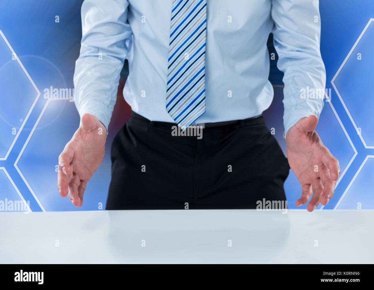 Digital composite of Man opening hands and interacting with hexagons ...