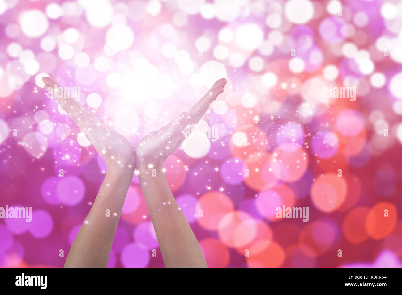 Hands gesturing against white background against glowing background Stock Photo