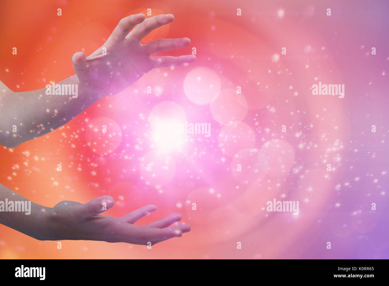 Hands gesturing against white background against glowing background Stock Photo