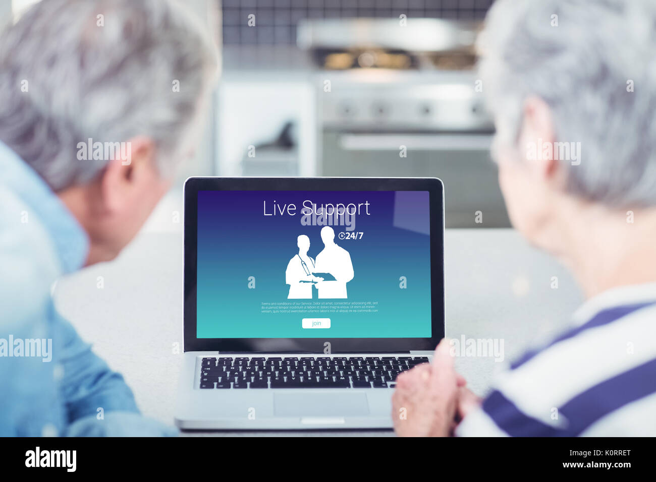 Human representations with live support text against senior couple looking at laptop at home Stock Photo