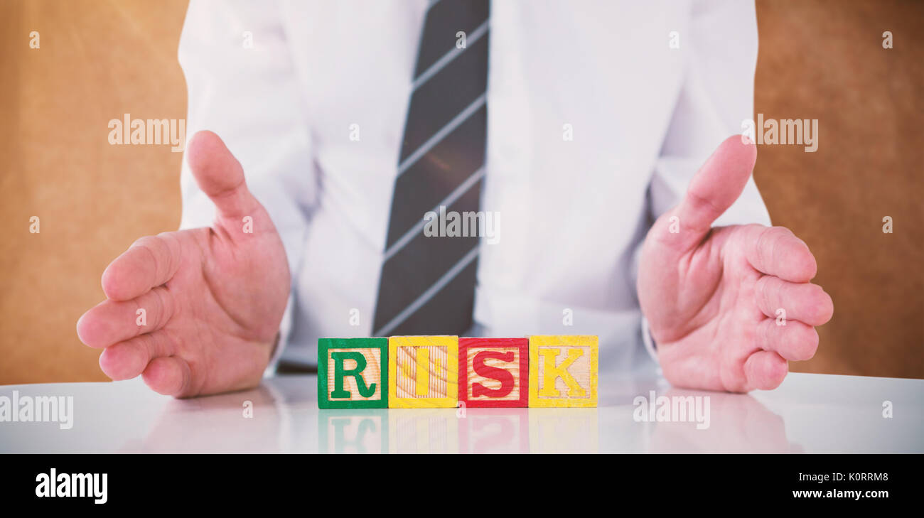 Mid section of businessman with risk text against brown grocery bag texture Stock Photo
