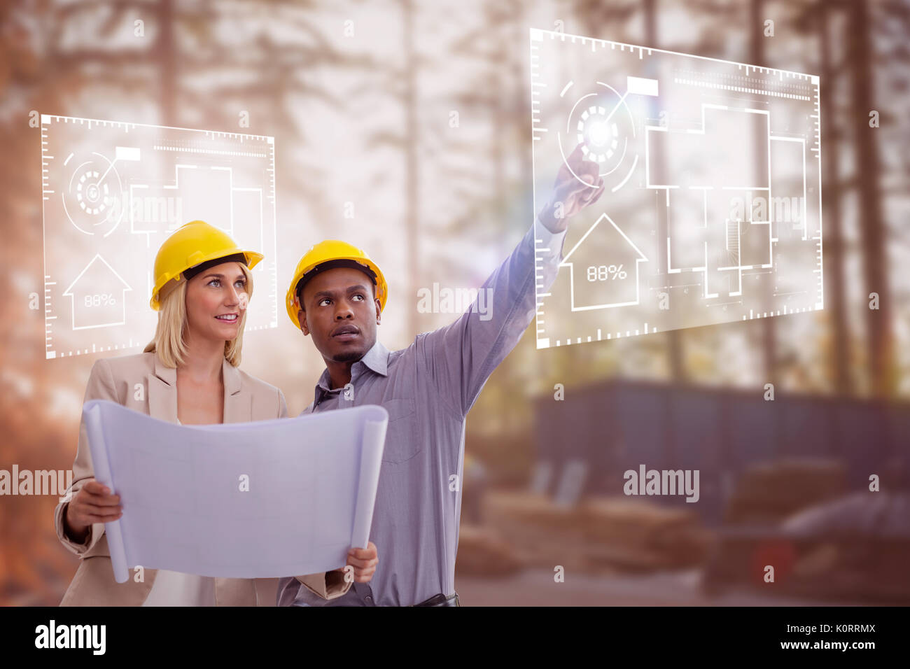 Man gesturing while standing with female architect against construction worker working at site Stock Photo