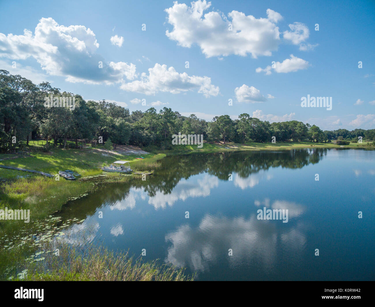 Scenic lake reflecting clouds in blue sky Stock Photo