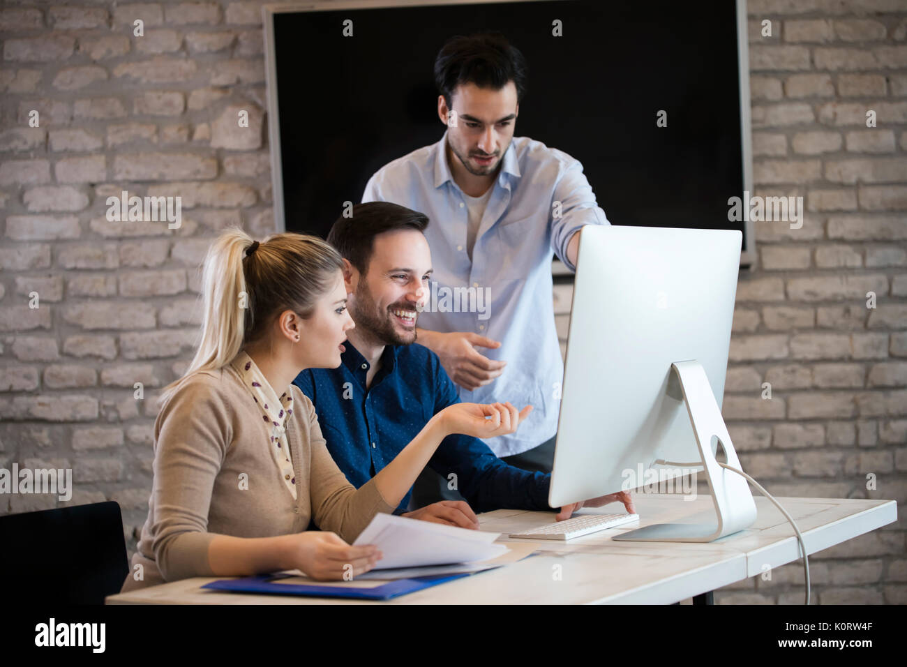 Group of young designers working as team Stock Photo - Alamy