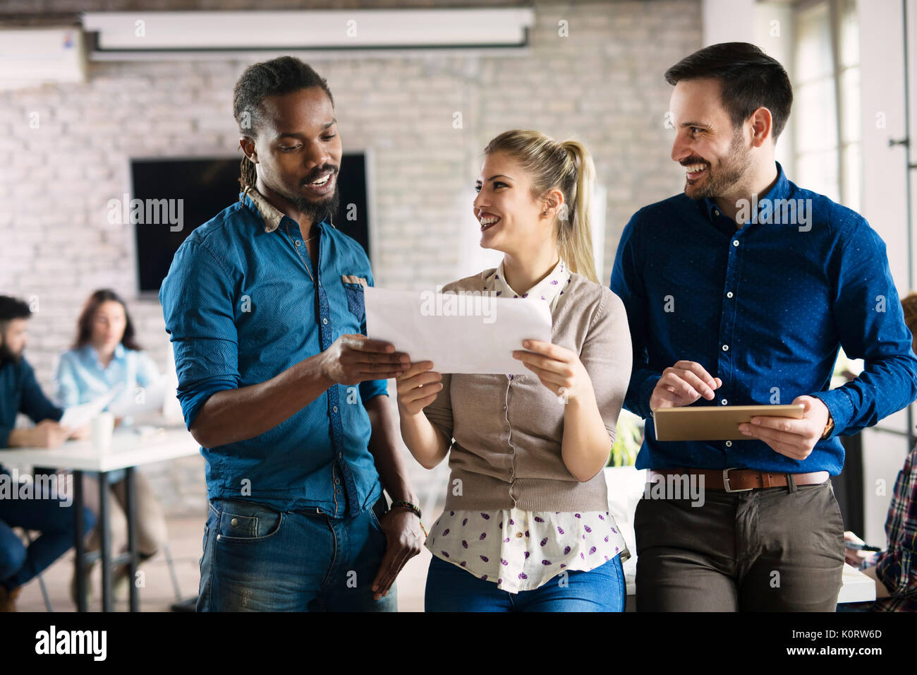 Picture of group of young perspective designers discussing Stock Photo ...