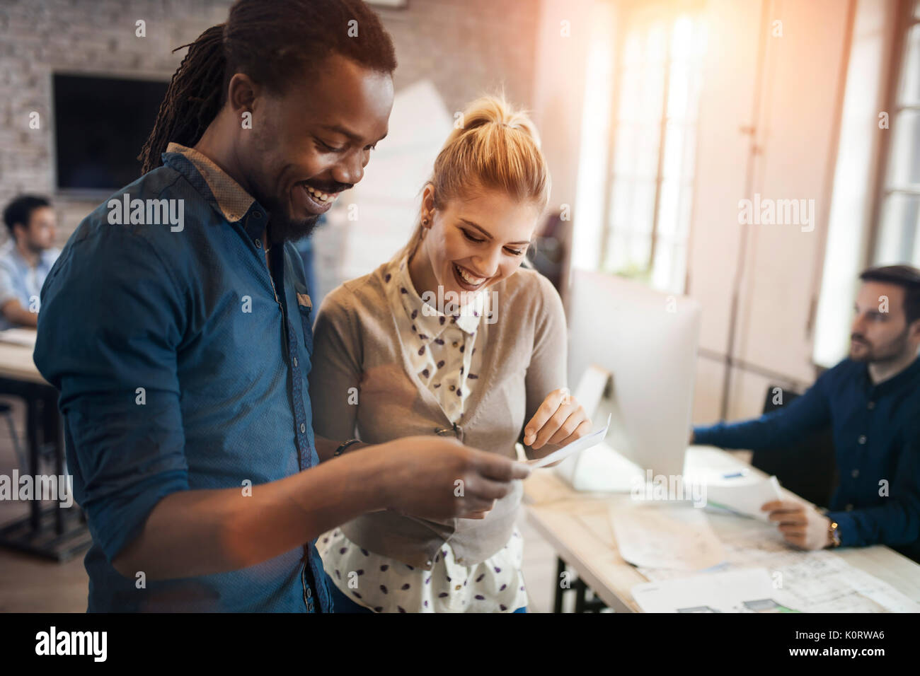 Picture of young designers discussing in office Stock Photo - Alamy