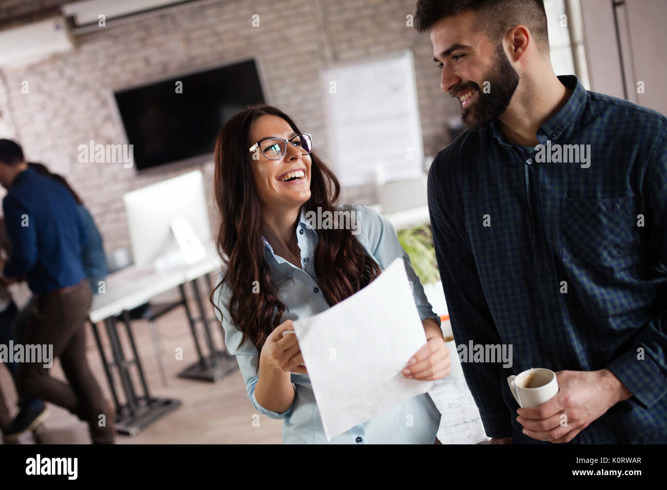 Picture of young designers discussing in office Stock Photo