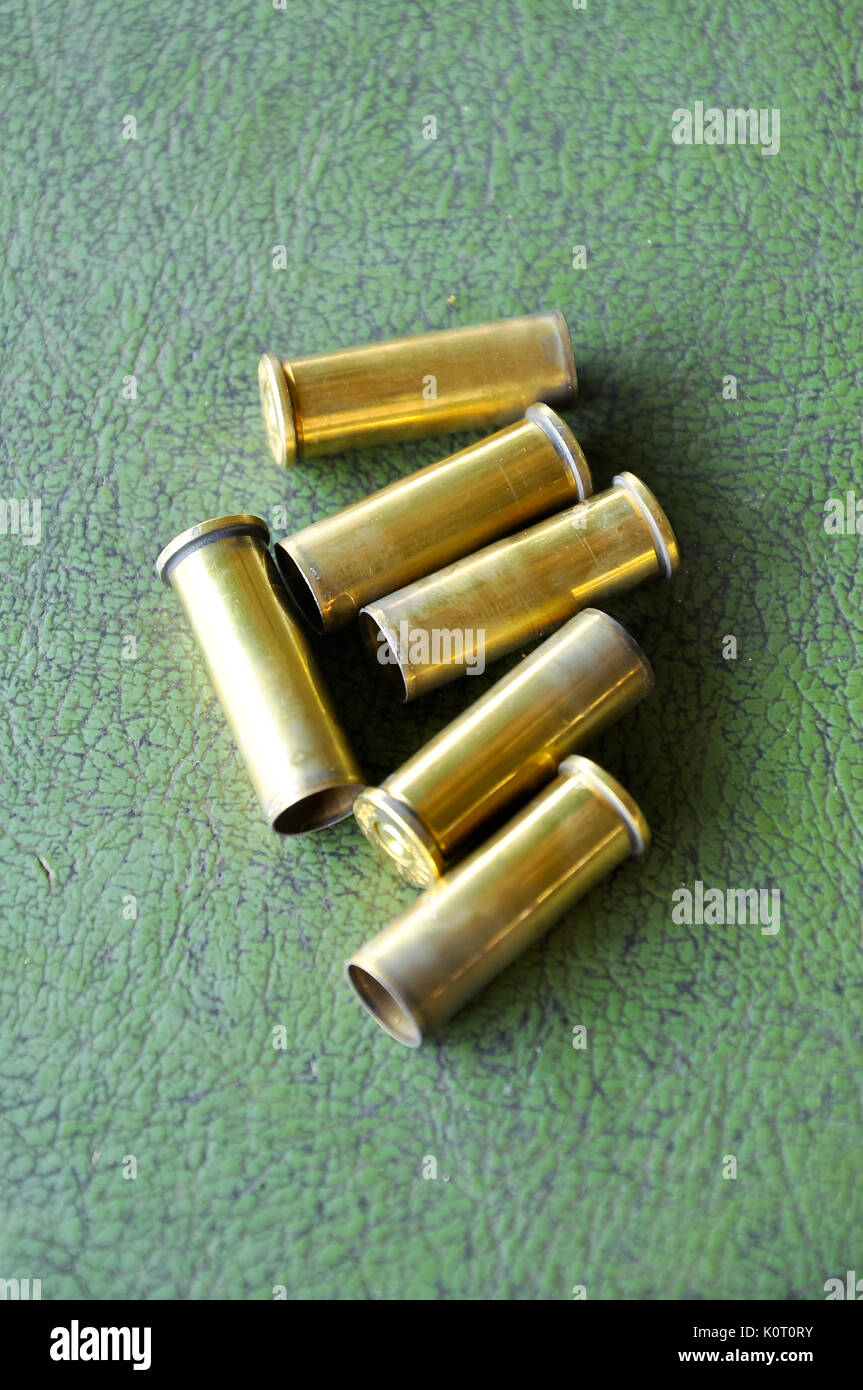 a casing containing a charge and a bullet or shot for small arms