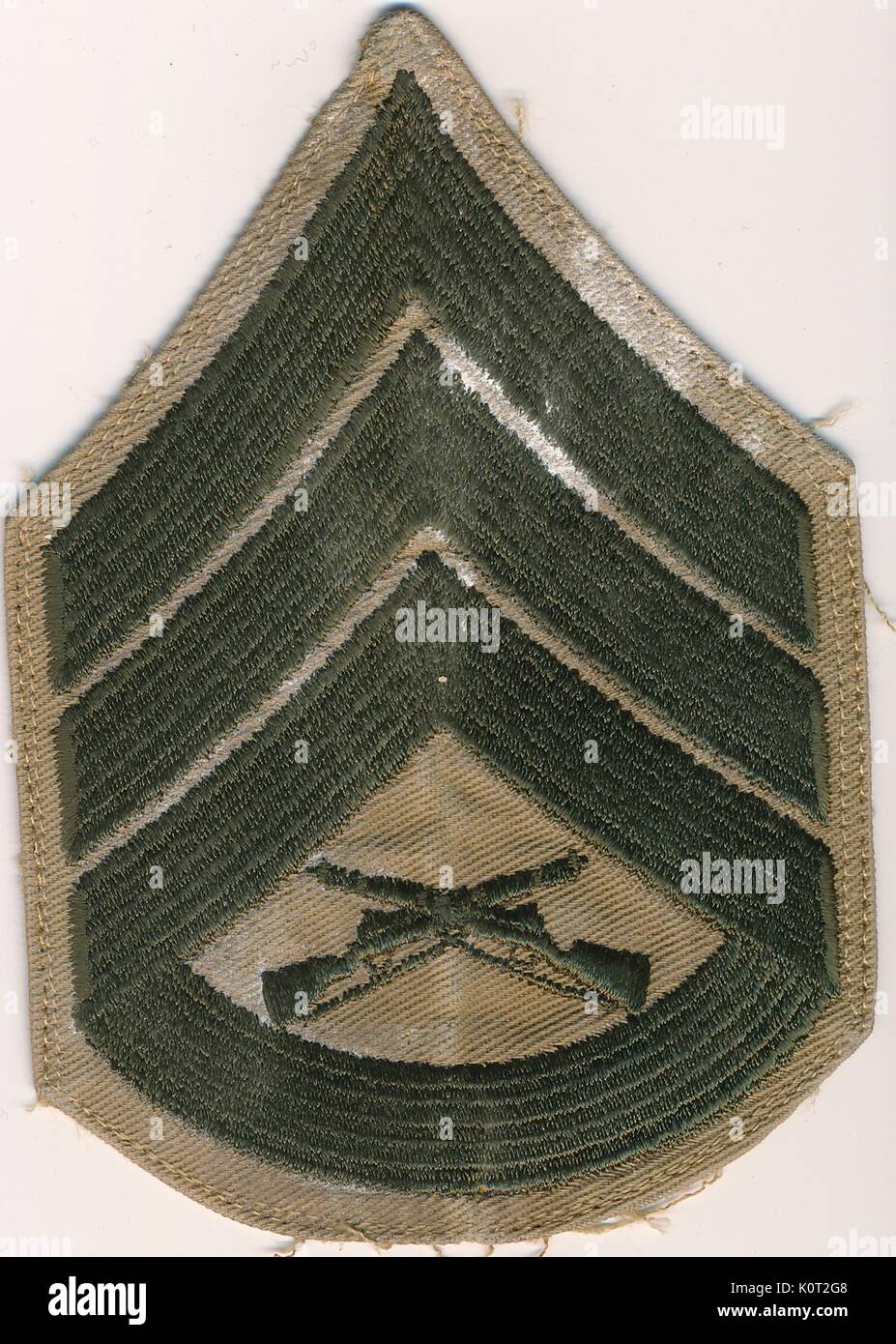 Gunnery Sergeant insignia patch from the Vietnam War, green and tan color, featuring two crossed rifles, 1964. Stock Photo