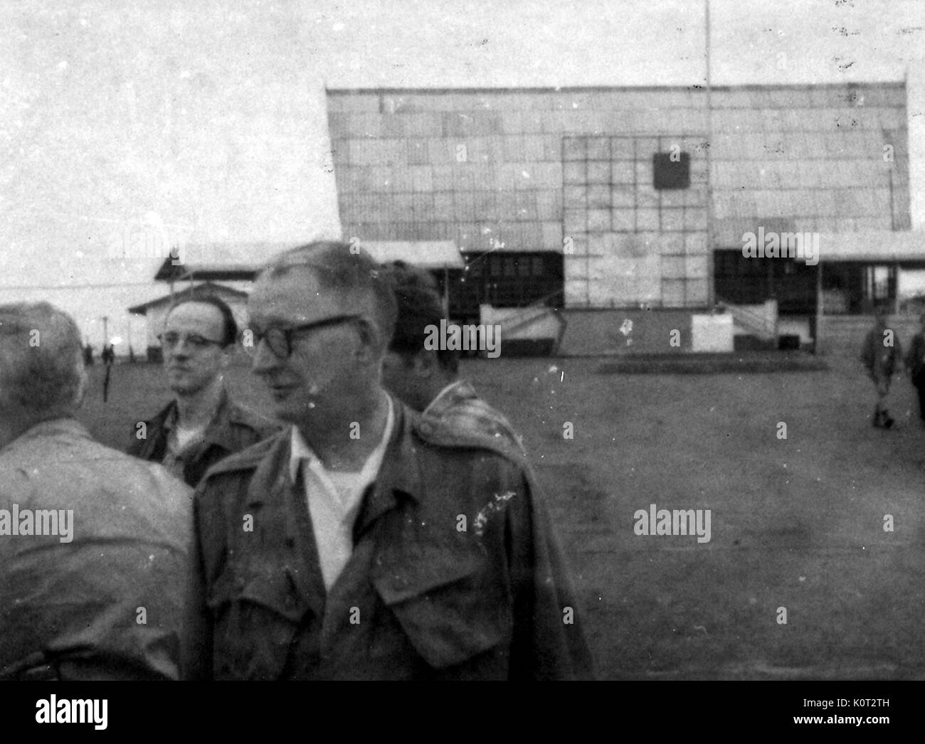 Blurred photograph of American servicemen at an airfield in Vietnam during the Vietnam War, one service men wearing glasses and standing in the front of the frame, 1966. Stock Photo