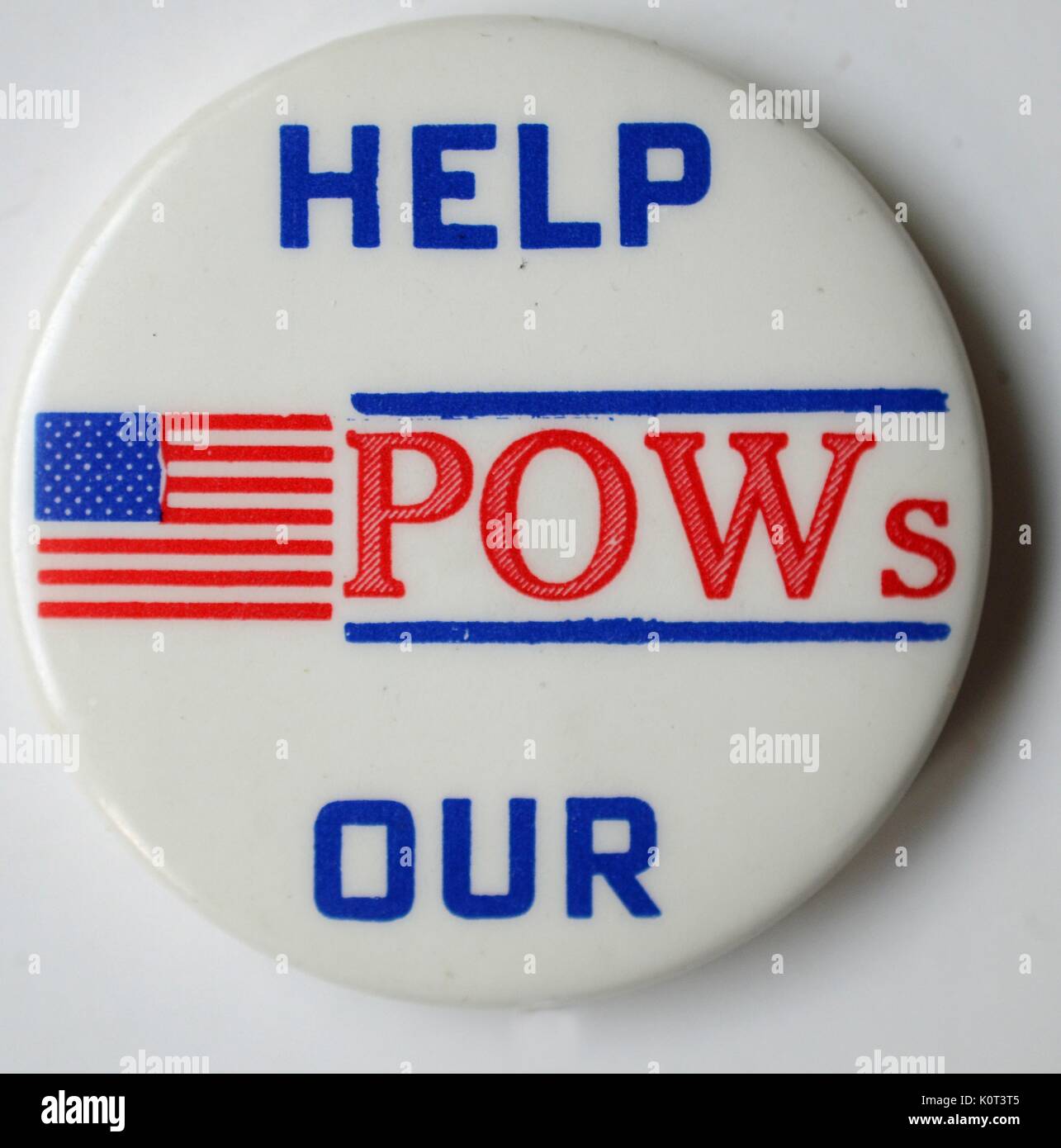 Help Our POWS, a pin expressing support for American prisoners of war during the Vietnam War, with red, white and blue lettering and an image of the American flag, 1965. Stock Photo