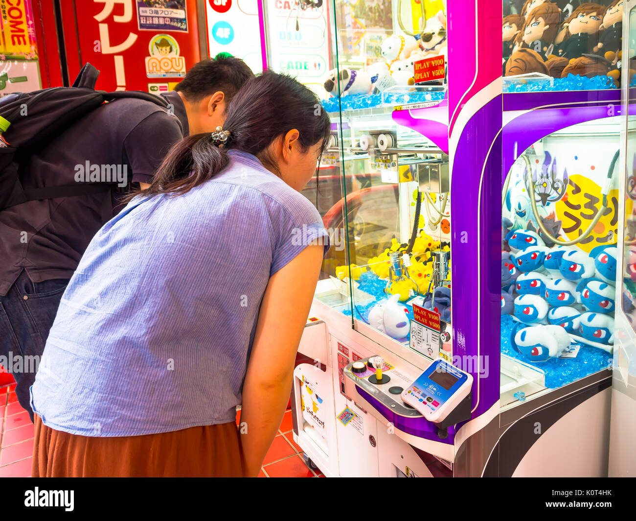 TOKYO, JAPAN JUNE 28 - 2017: Unidentified people looking the assorted hello Kitty dolls in a toy coin machine in Tokyo Stock Photo