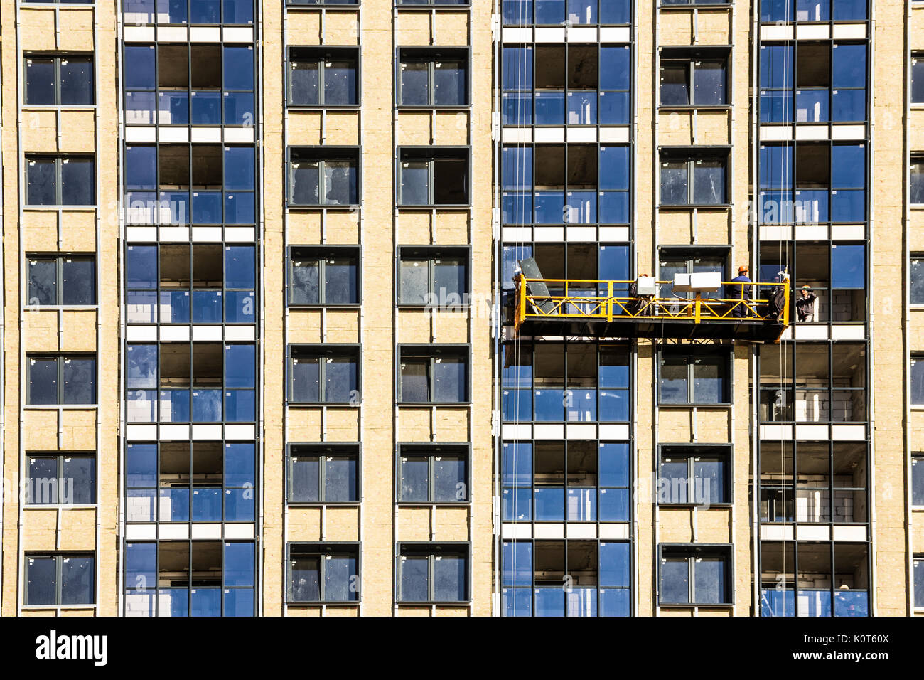 Construction decoration work of the facade by builders in a