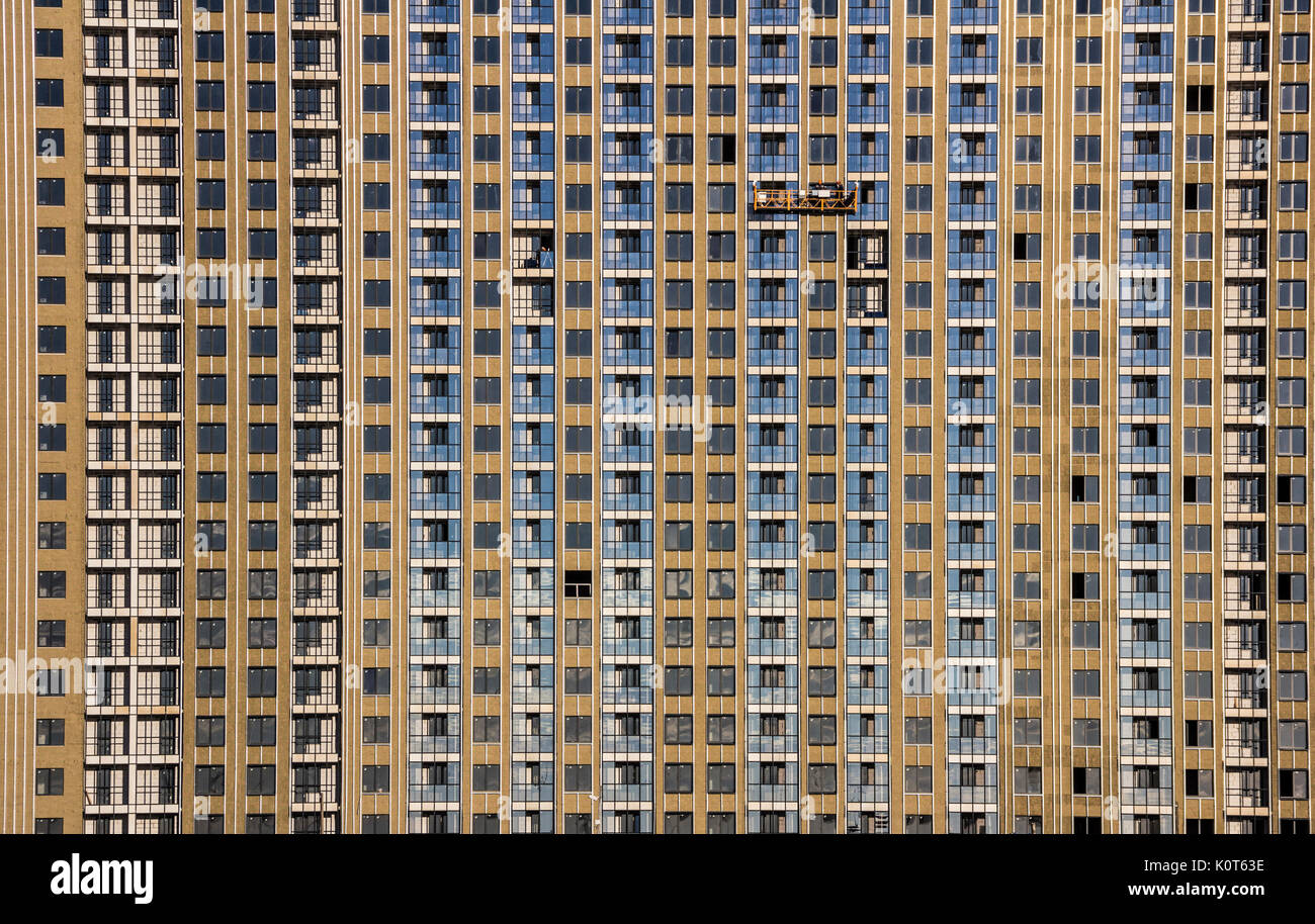 Construction decoration work of the facade by builders in a