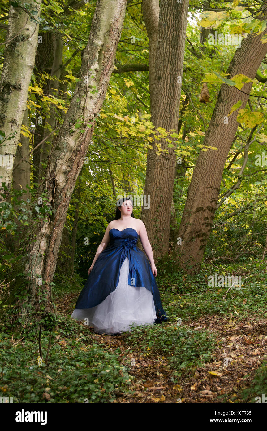 Pretty girl in a forest wearing a long dress Stock Photo - Alamy