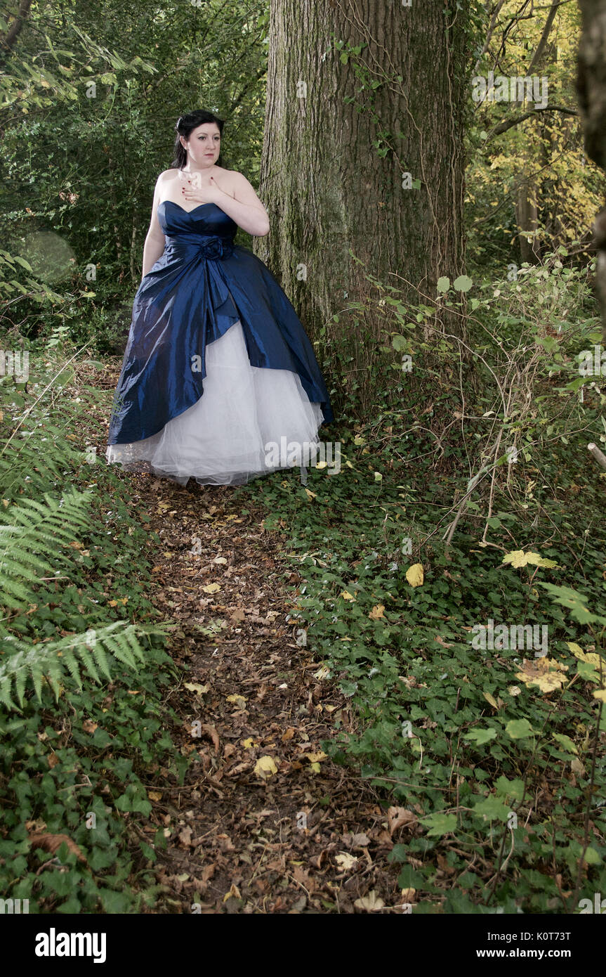 Pretty girl in a forest wearing a long dress Stock Photo - Alamy