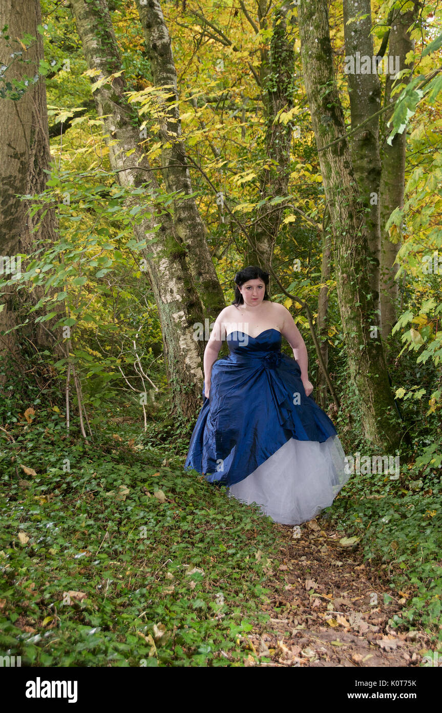 Pretty girl in a forest wearing a long dress Stock Photo - Alamy