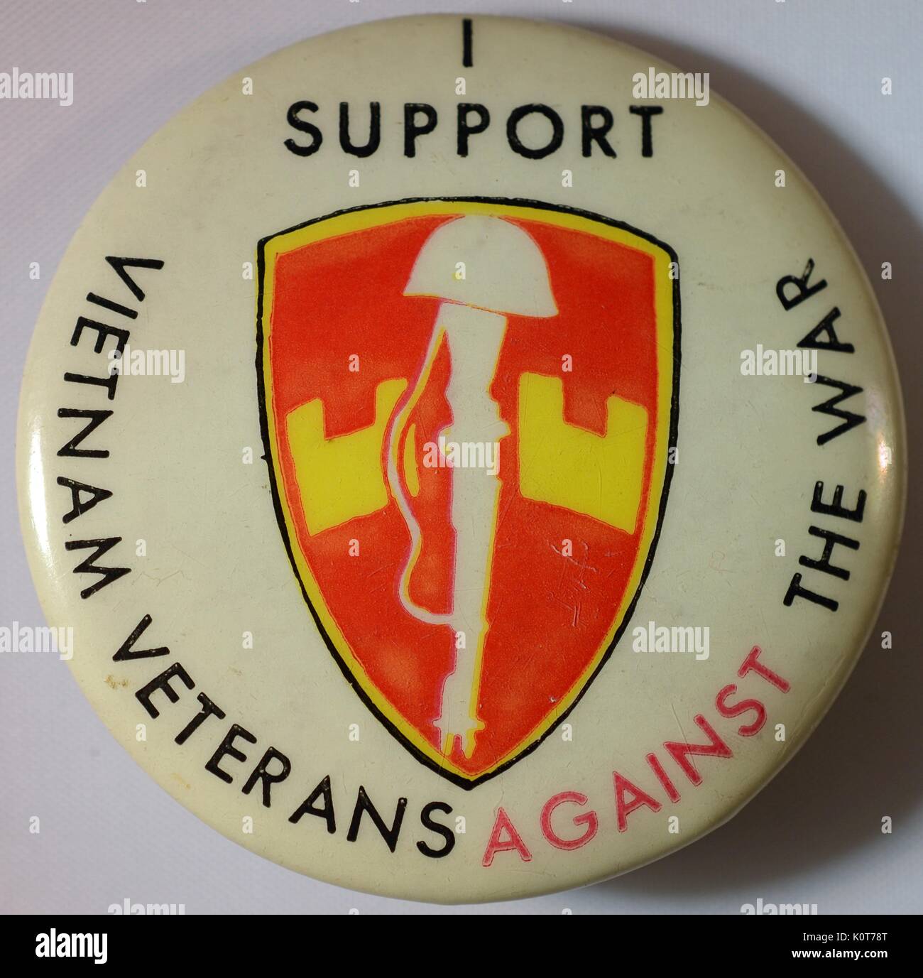 An anti-Vietnam War pin featuring a battlefield cross and
