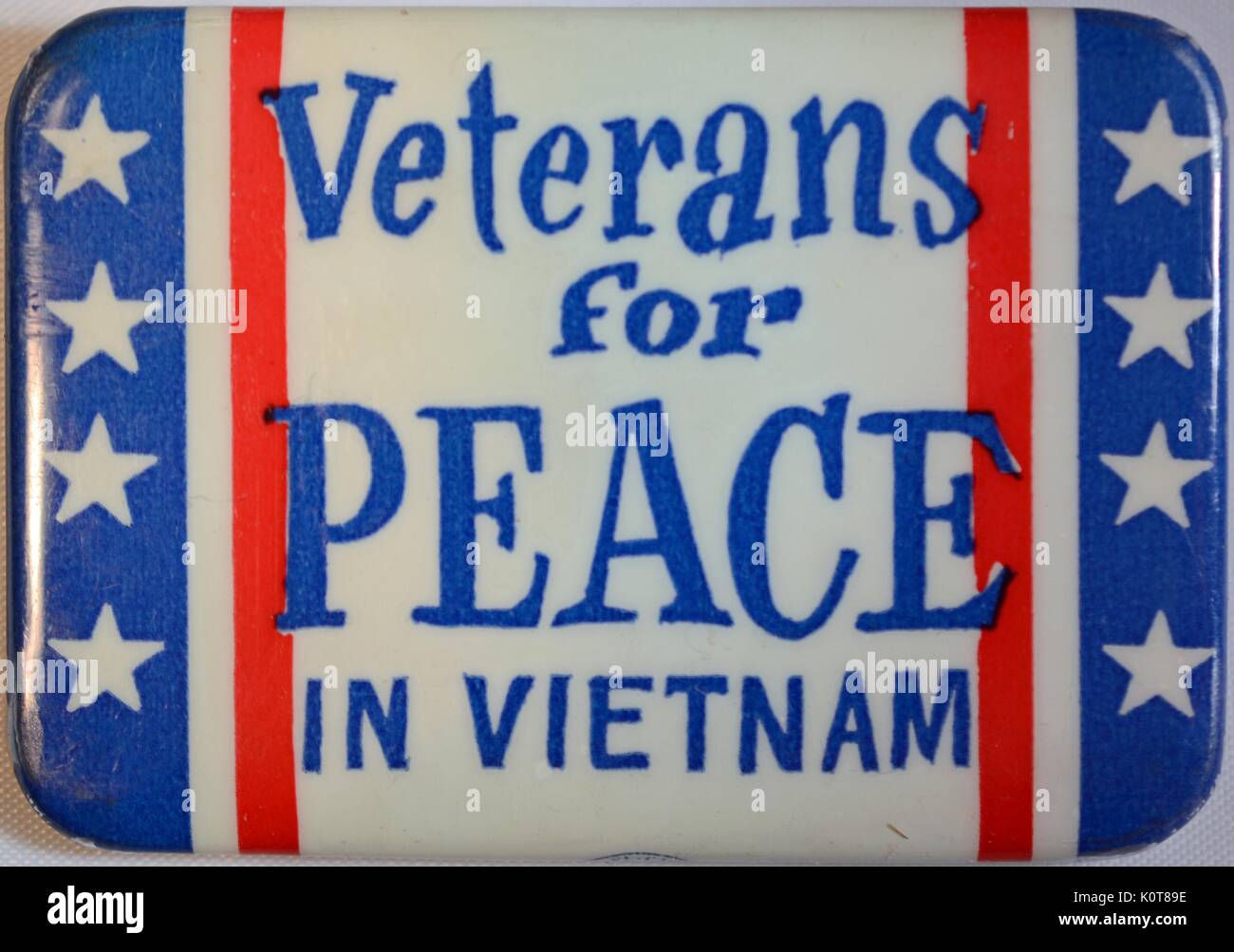 An anti-Vietnam War protest pin that contains the text 'Veterans for Peace in Vietnam', the background consists of the colors red, white and blue along with white stars, 1968. Stock Photo