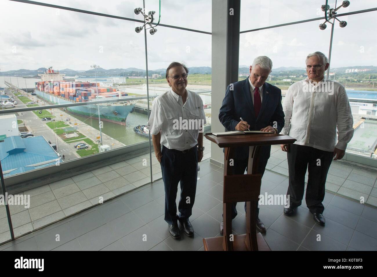 U.S. Vice President Mike Pence, signs the guest book as he arrives for a tour of the Panama Canal with Administrator Jorge Quijano, right, August 17, 2017 in Panama City, Panama. Pence has been on a week-long tour of Latin America. Stock Photo