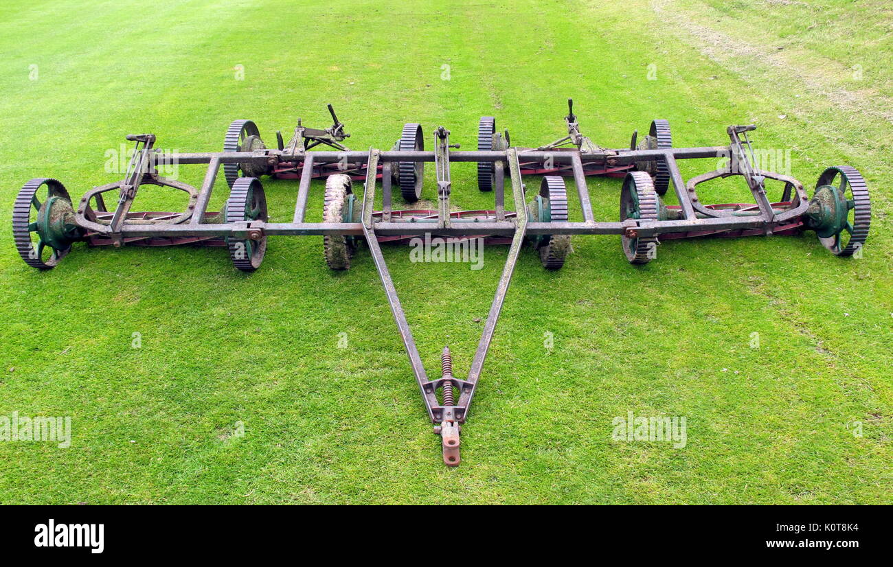 vintage lawn mower tractor  cutting blades green grass pitch  Hamilton Crescent cricket ground Glasgow, Scotland historic football  location Stock Photo