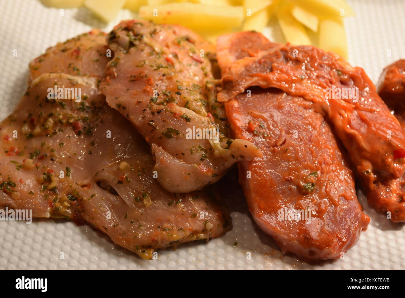 Raw chicken and pork fillet with chips Stock Photo Alamy