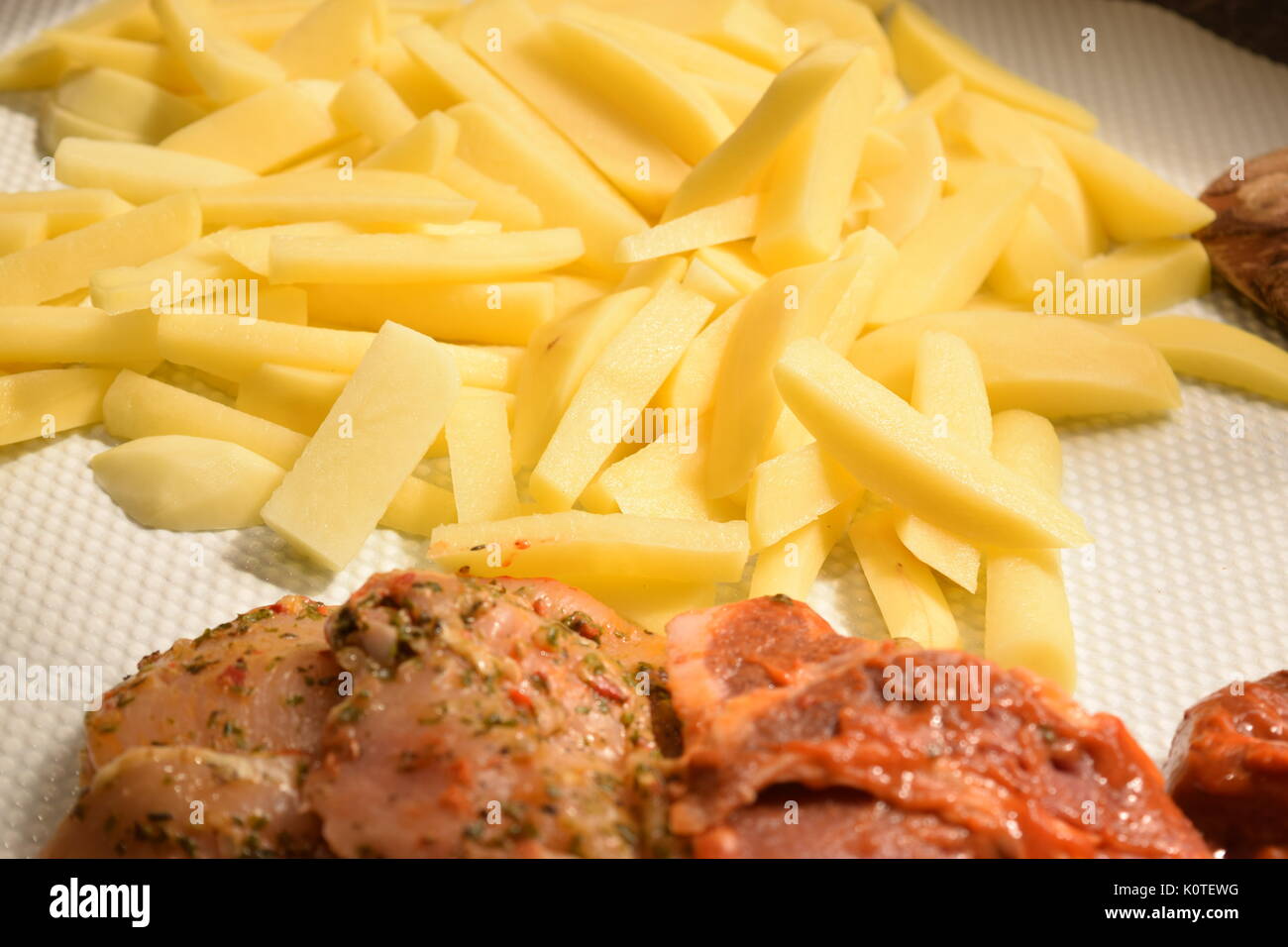 Raw chicken and pork fillet with chips Stock Photo Alamy