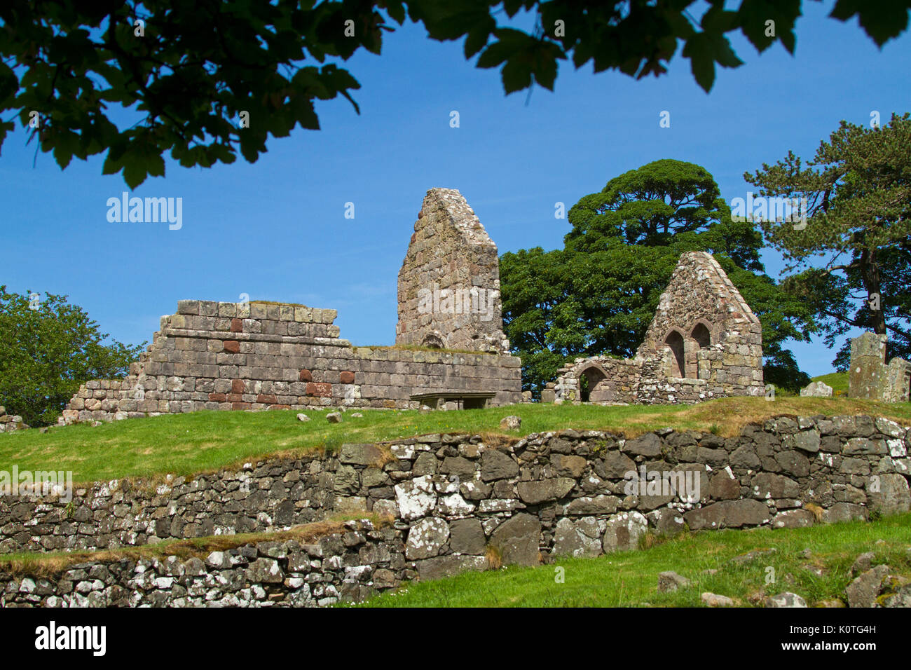 Ruins of historic 13th century Saint Blane's church and monastery against blue sky on island of Bute, Scotland Stock Photo
