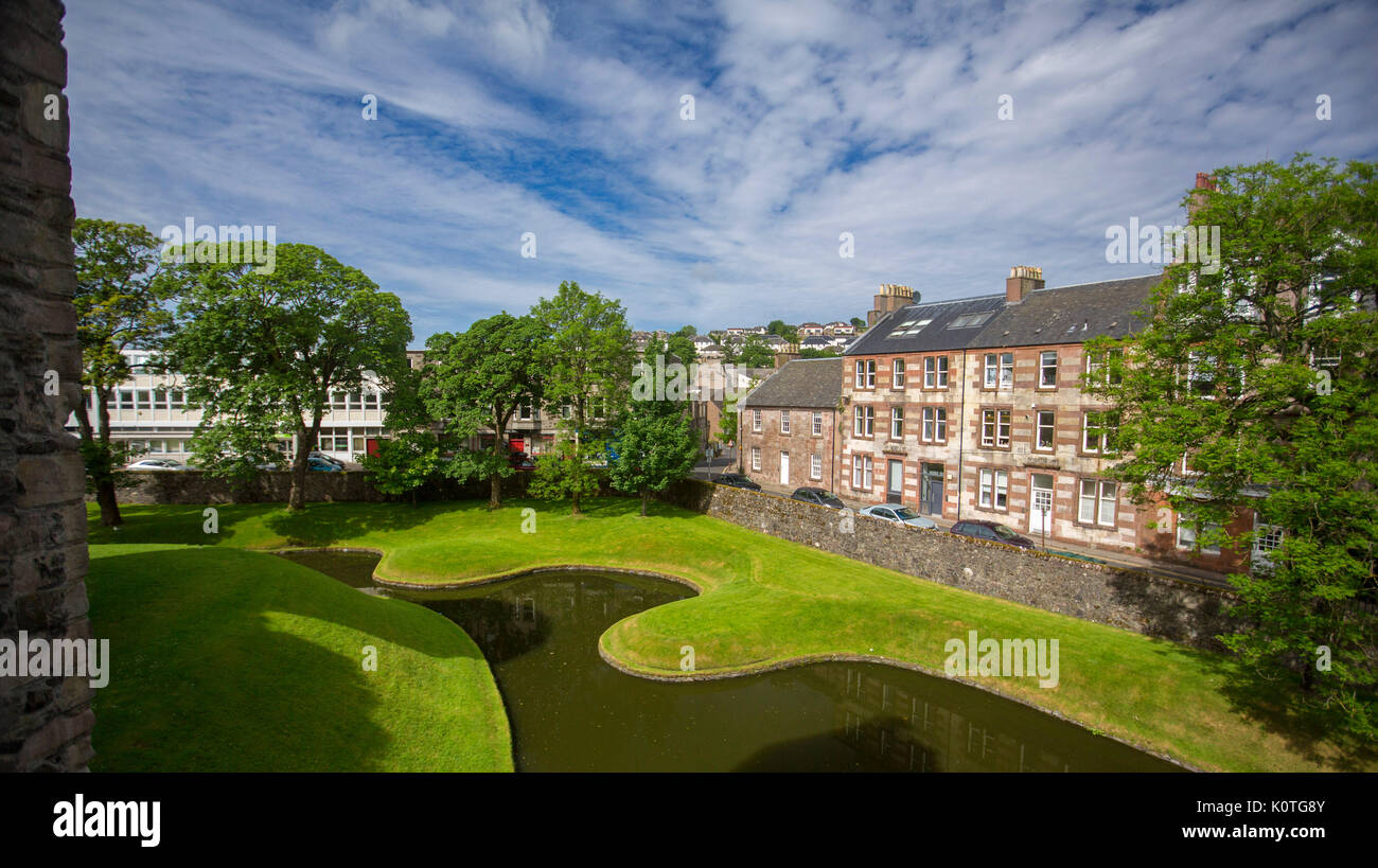Panoramic view, from historic castle, of town of Rothesay with water of moat in foreground under blue sky on island of Bute, Scotland Stock Photo