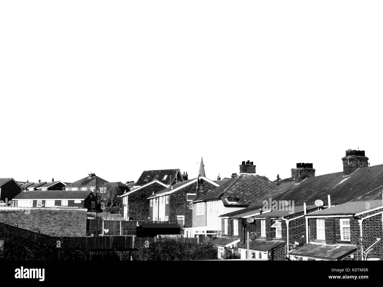 black and white English housing and top of church. Traditional British Village. Brick house on sunny day in winter. Stock Photo