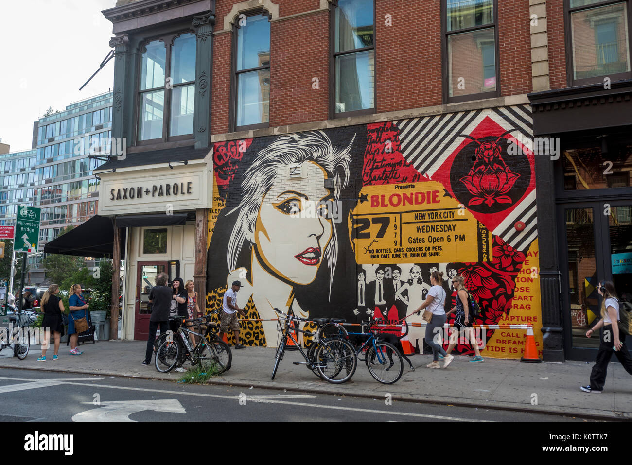 New York, USA. 23rd Aug, 2017. Passersby stop to admire a newly completed mural, by Shepard Fairey, in the East Village. The mural features Debbie Harry, lead singer for the rock group Blondie, who got their start in 1979 at CBGB which was located across the street. Fairy's work is also featured in Blondie's latest album “Polinator” which was released in May 2017 Credit: Stacy Walsh Rosenstock/Alamy Live News Stock Photo
